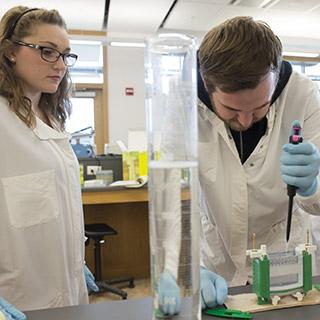 Physics student working on an experiment in a science lab